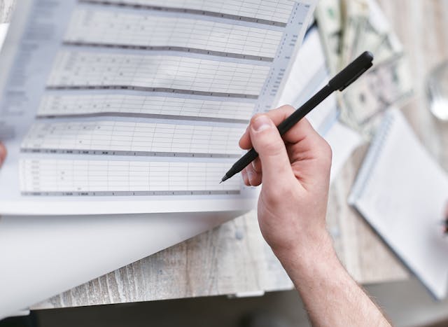 A spreadsheet and papers with financial data